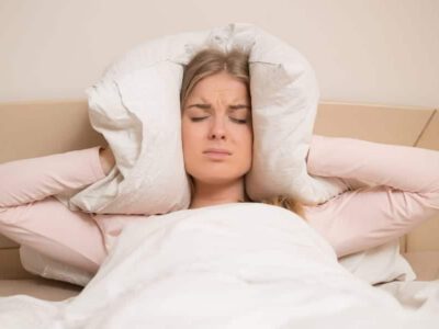 woman covering her ears loud sound 1