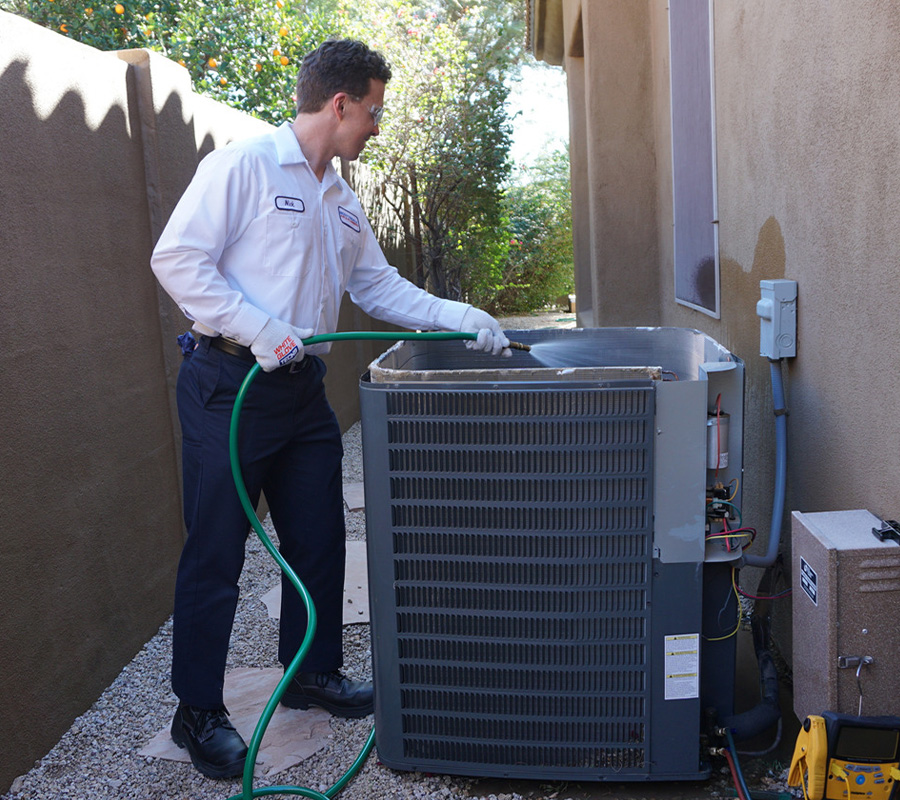 Scottsdale Air technician performing an AC tune-up on an outdoor unit